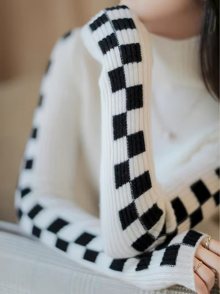 Stylish unisex turtleneck sweater with a distinct checkerboard sleeve design. A modern fit.