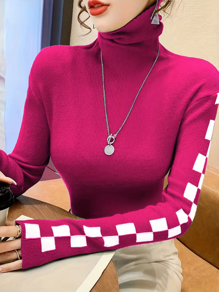 Statement piece: long sleeve unisex sweater with eye-catching checkerboard pattern on sleeves.