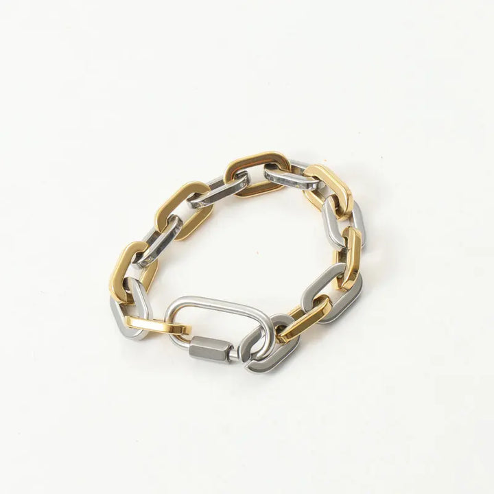 Chunky gold-plated two-tone bracelet, stainless steel construction. Modern, durable unisex statement jewelry piece.