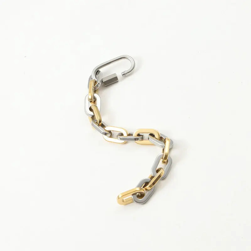 Unisex chunky gold-plated stainless steel bracelet. Two-tone modern design for a versatile statement look.