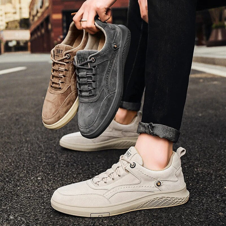Classic grey suede sneakers, offering a blend of versatile style and everyday comfort for all.