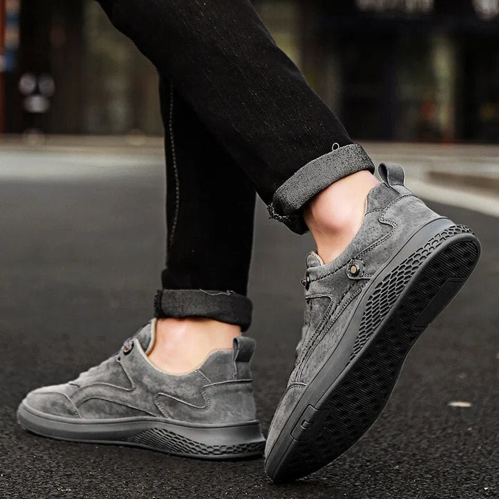 Side view of classic grey suede sneakers, showcasing timeless style & comfort features.