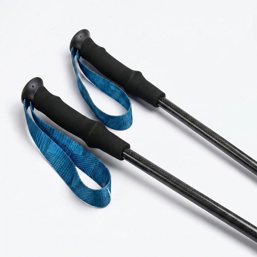 Folded carbon fiber trekking poles, compact and lightweight, perfect for travel and storage in hiking backpacks.