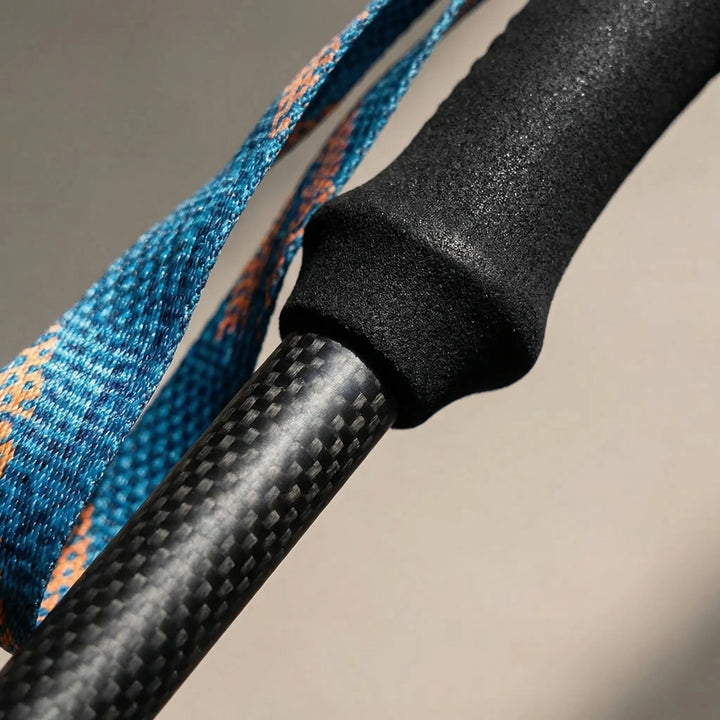 Unisex carbon fiber hiking poles, extended and ready for challenging trails. Durable, lightweight walking stick.