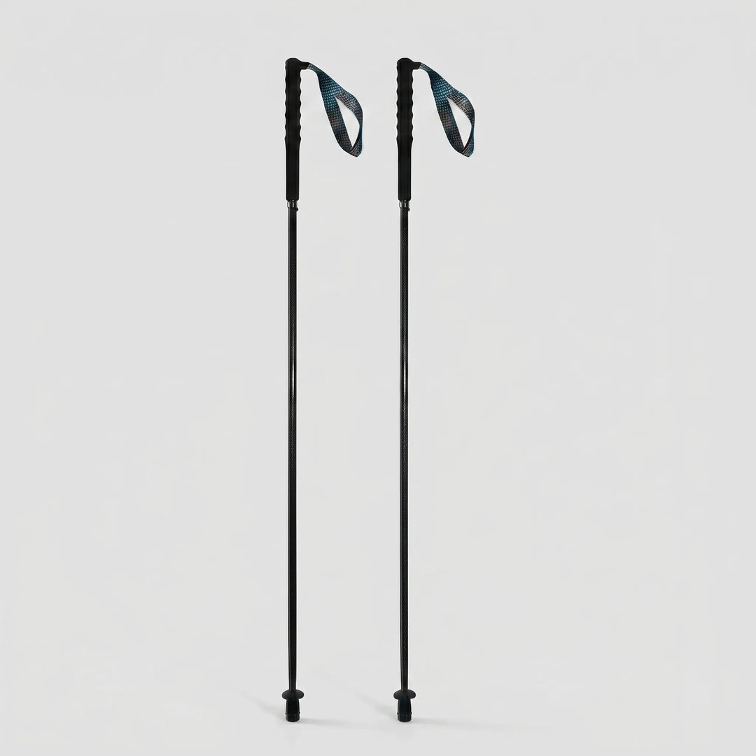 Collapsible carbon fiber trekking pole attached to a backpack, ready for an outdoor adventure. Lightweight & compact.