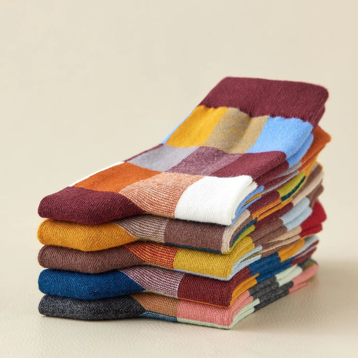 Close-up of colorful patchwork socks, showcasing unique retro color theory design. Unisex fashion accessory.