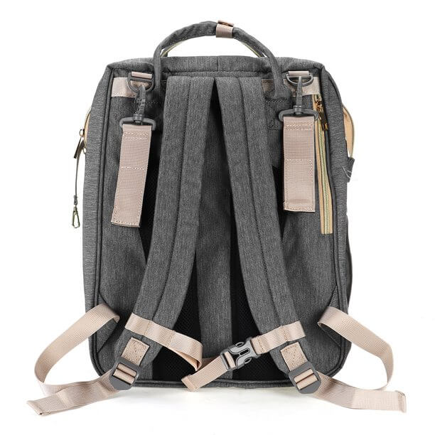 Compact nappy bag backpack with a folded bassinet compartment, ready for travel