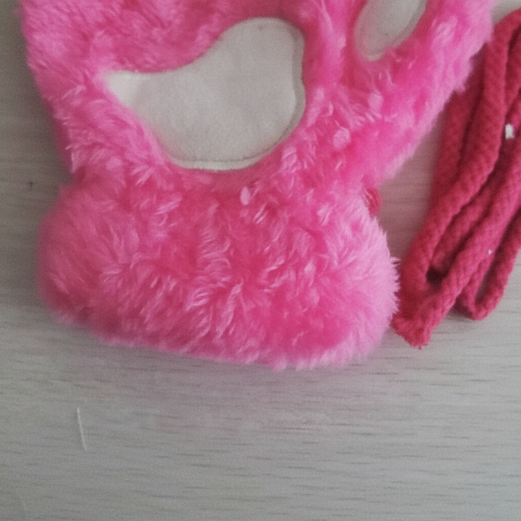 Close-up of plush fingerless paw print gloves in black, showcasing cozy winter accessory