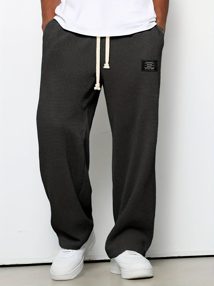 Soft fabric unisex waffle lounge pants with a wide leg and adjustable drawstring for ultimate comfort.