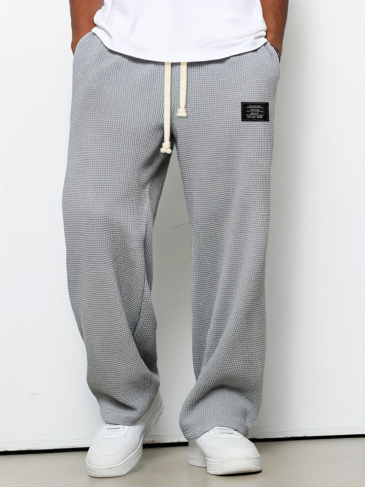 Cozy unisex waffle knit drawstring pants with a relaxed, wide-leg fit for everyday casual comfort.