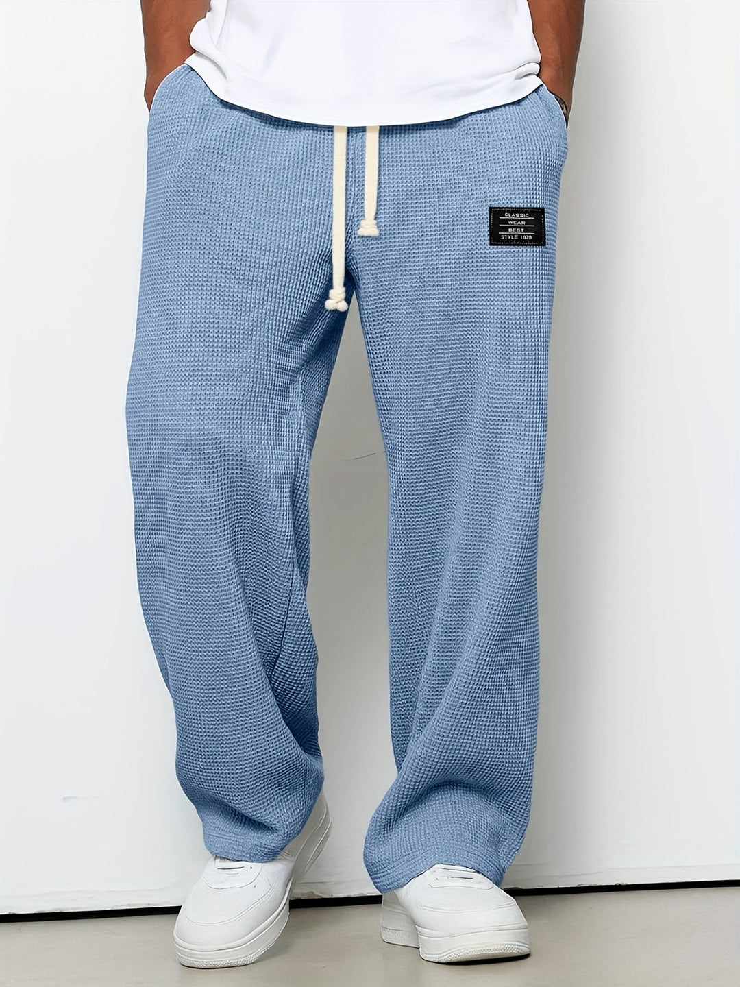 Unisex waffle knit drawstring lounge pants in a relaxed fit, made from soft, cozy fabric.
