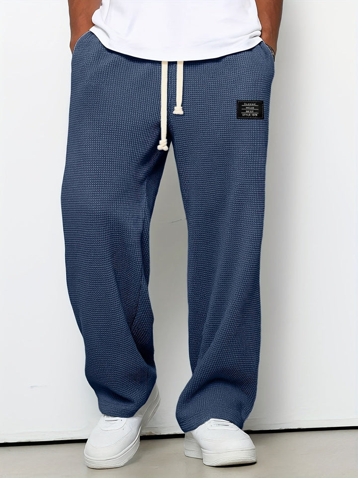 Casual wear unisex lounge pants, waffle knit texture, offering a relaxed wide leg and supreme comfort.