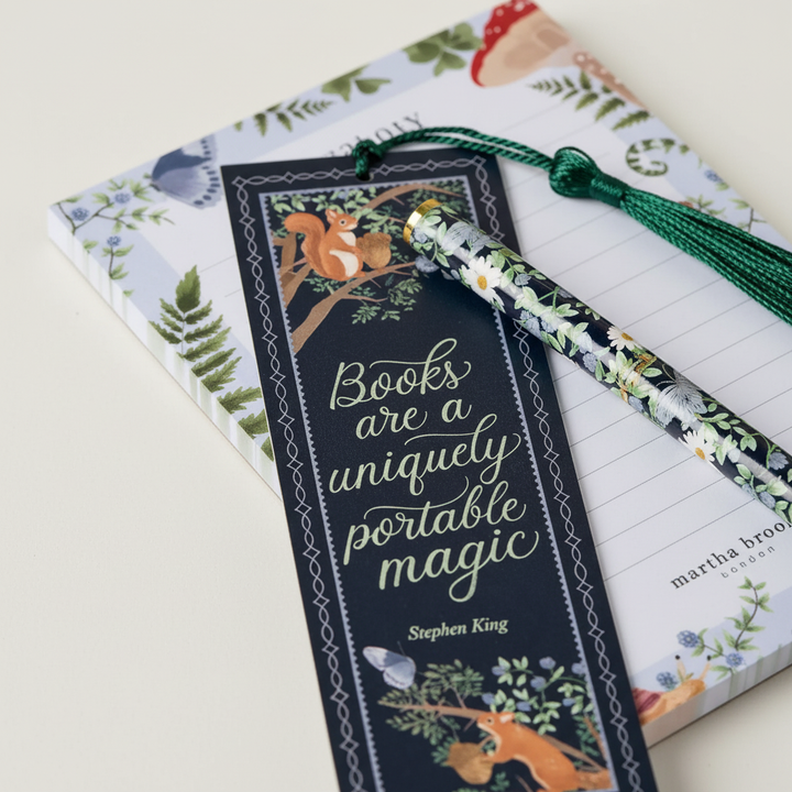 Open creative stationery advent calendar revealing an assortment of mini notebooks and colorful pens