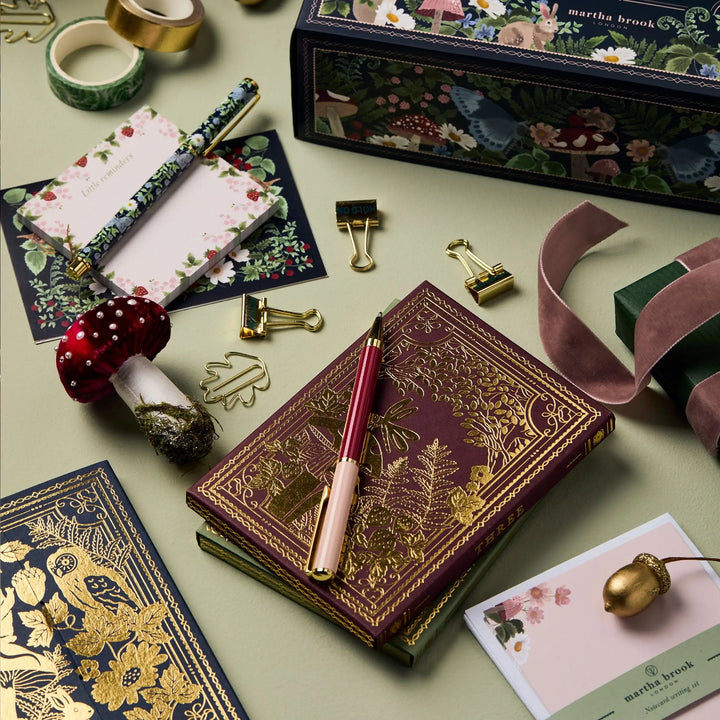 Hands opening a door on a DIY stationery advent calendar, revealing a small, fun writing tool