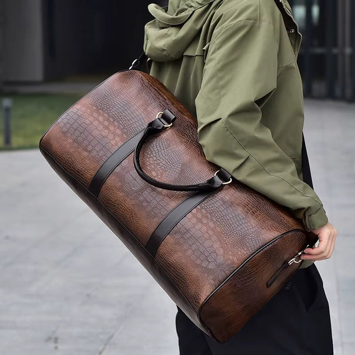 Chic unisex croc-embossed vegan leather duffle bag. Fashionable & ethical weekender travel accessory.