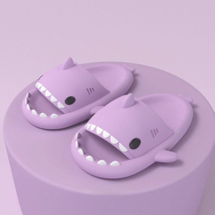 Top-down view of a pair of cushioned shark slides, highlighting the comfortable, soft design