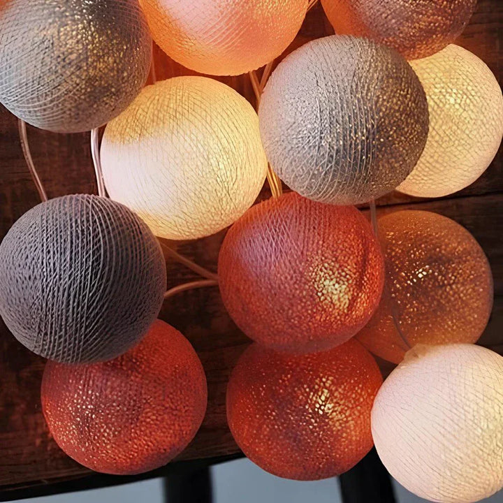 Decorative string lights with various sized cotton balls, creating depth in home lighting.