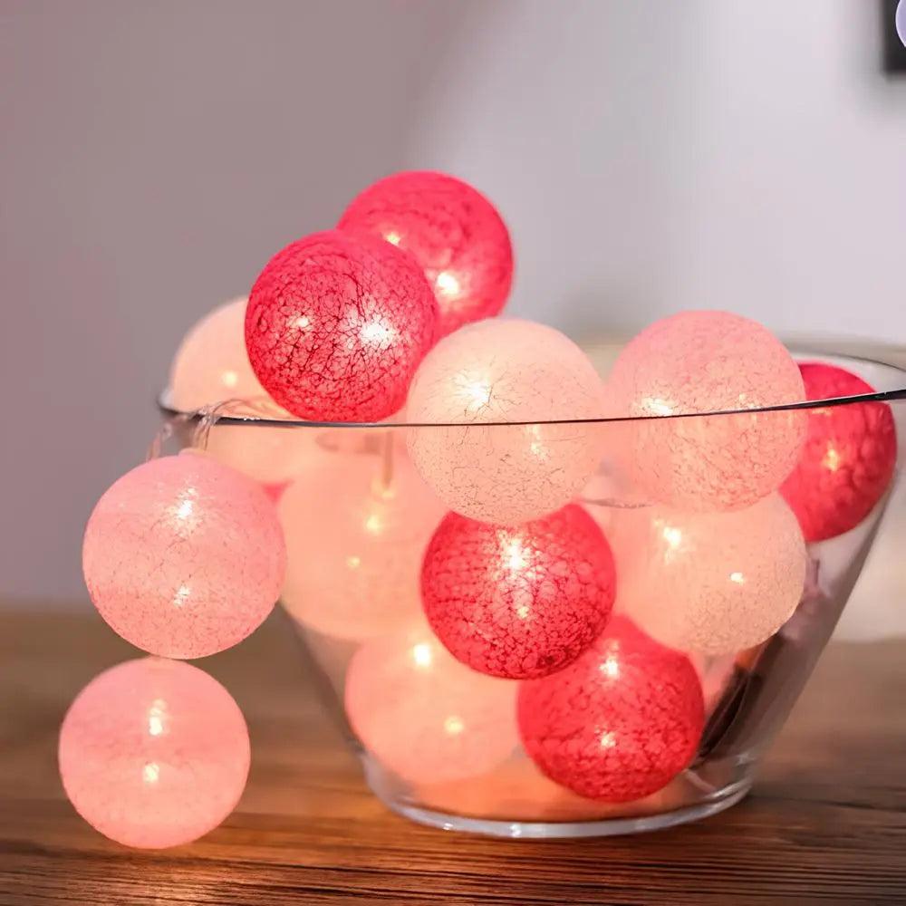 LumaBreeze cotton ball string lights displaying their gentle and warm illumination against a dark background.