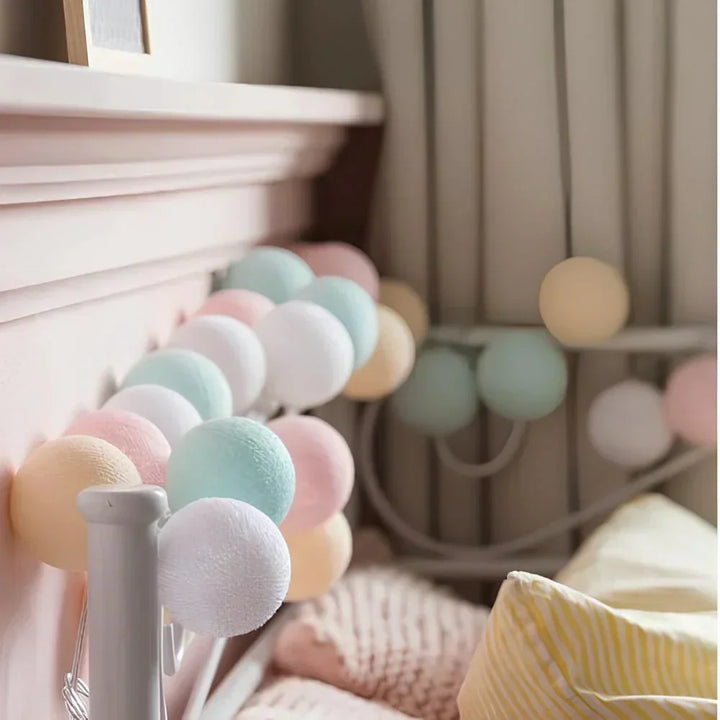 Close-up of a LumaBreeze cotton ball light, showcasing its texture and warm illumination.