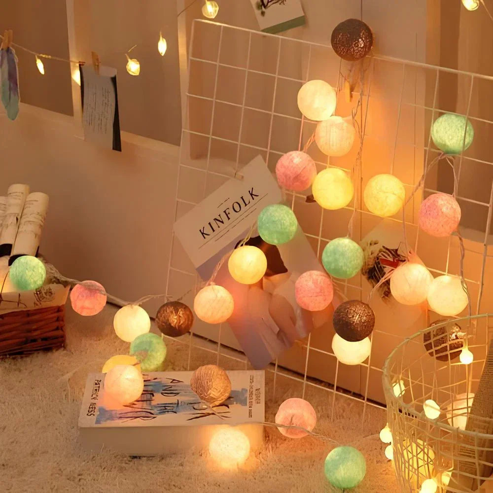 Cotton ball string lights draped over a headboard, enhancing bedroom decor with soft ambient light.