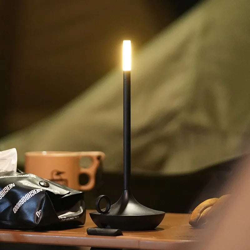 Modern unisex LED lamp, wireless candle holder providing ambient light with intuitive touch control.