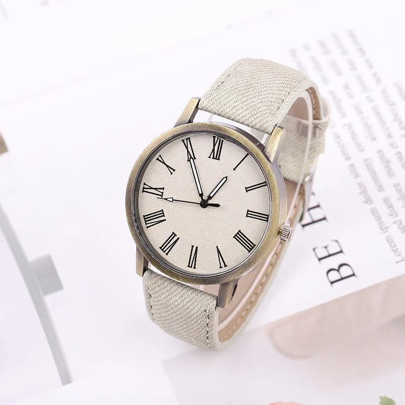 Versatile unisex watch with a casual denim strap & bronze-tone elements, suitable for any outfit.
