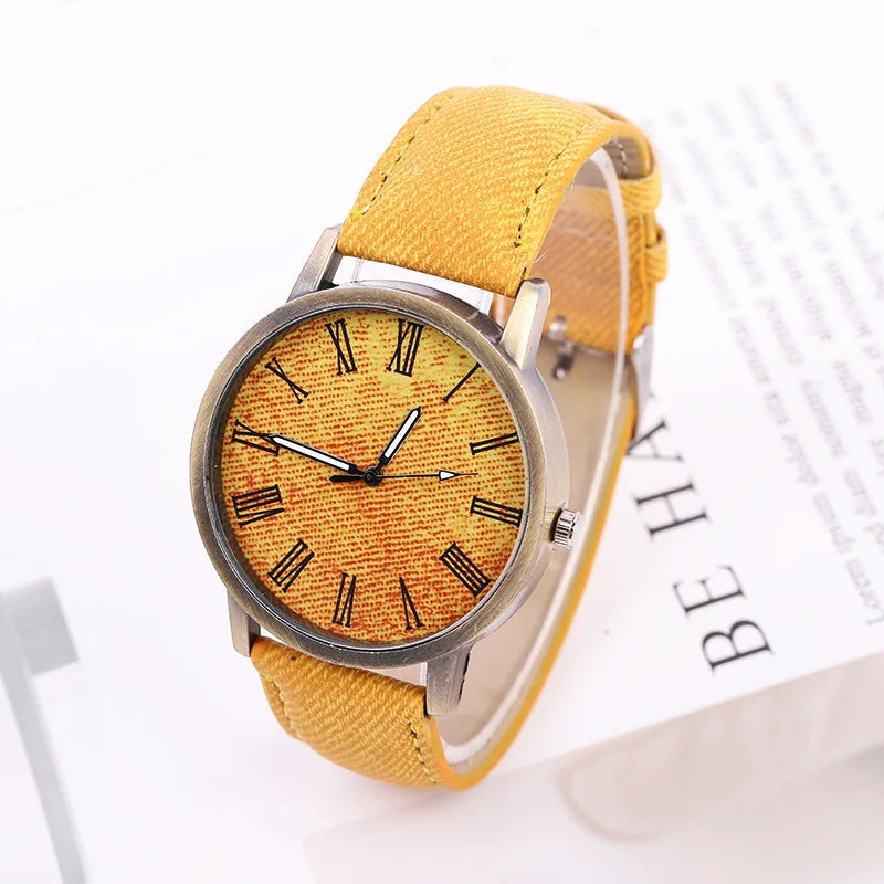 Blue denim strap unisex watch featuring a contrasting bronze dial & case, for a chic casual style.
