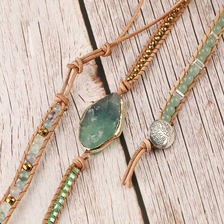 Hand holding a detoxifying fluorite wrap bracelet, highlighting the unique crystal colors