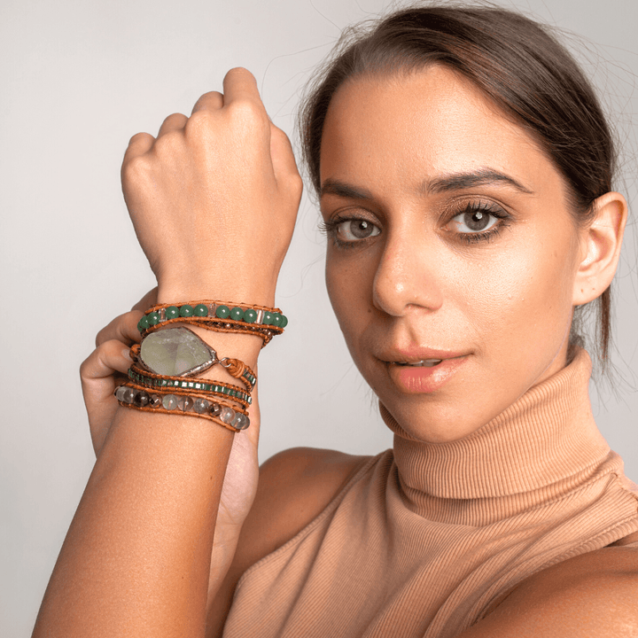 Stack of unisex fluorite and vegan leather wrap bracelets, ideal for crystal healing