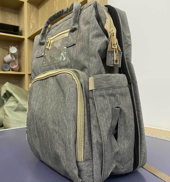 Compact, foldable diaper backpack ready for travel, easily converting to a bassinet for naptime.