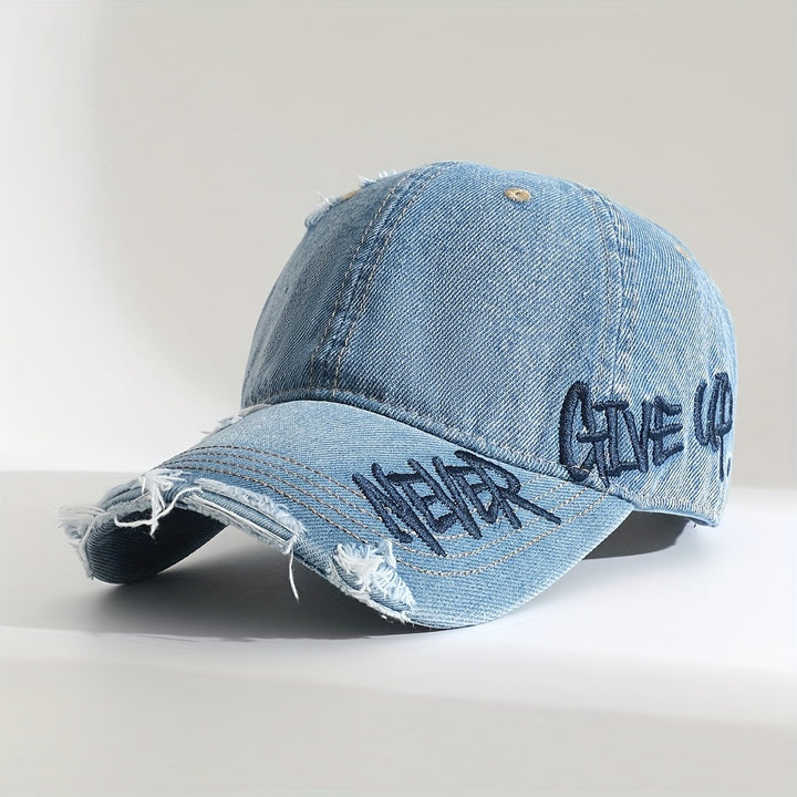 Unisex distressed denim cap with "Never Give Up" graffiti embroidery. Washed denim baseball cap, adjustable.