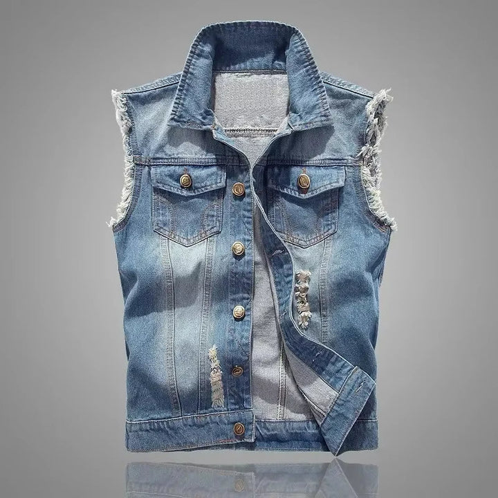 Edgy unisex sleeveless denim vest with extensive distressing, perfect for layering outerwear.