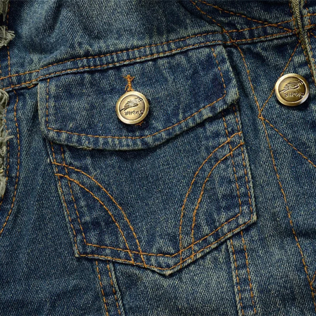 Sleeveless distressed denim vest, a versatile unisex outerwear piece for punk and rocker fashion.