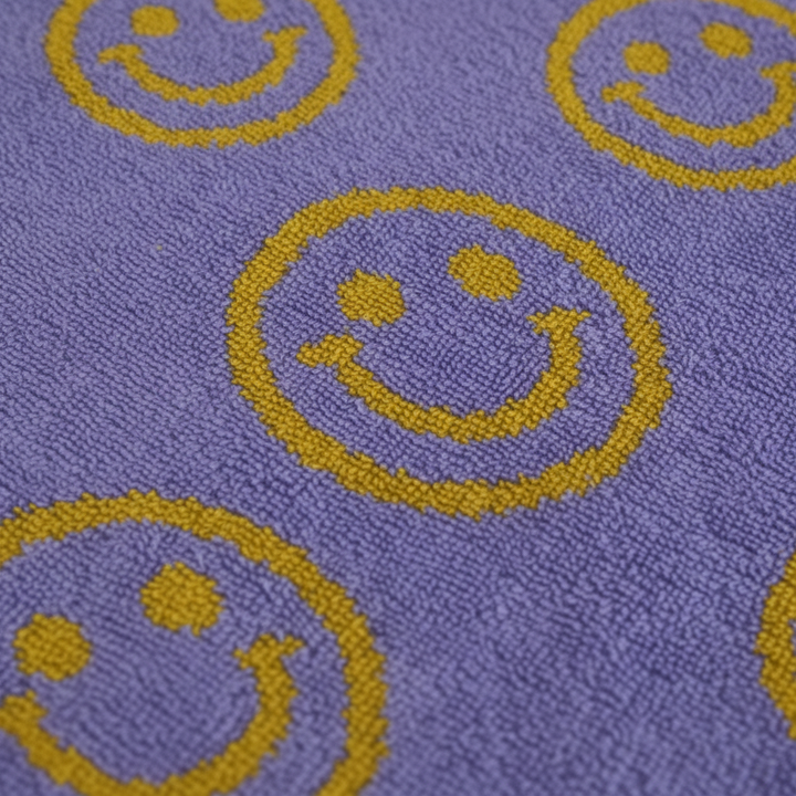 Stack of unisex smiley cotton bath towels, soft and absorbent for a happy bathroom