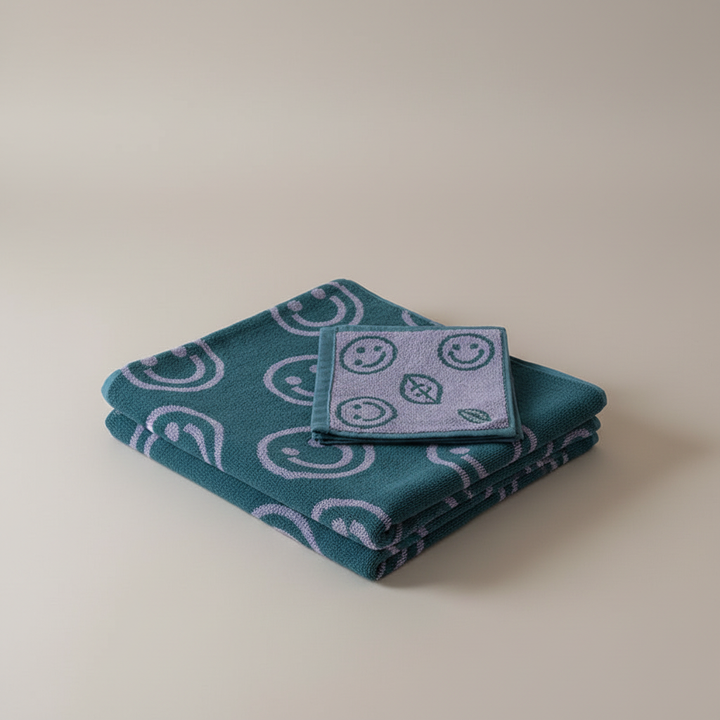 Vibrant yellow smiley cotton bath towel with a cheerful design, ideal bathroom decor
