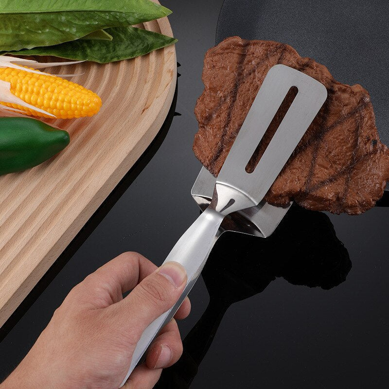 Unisex double-sided stainless steel spatula for easy flipping pancakes, eggs, and burgers on the grill or stove.