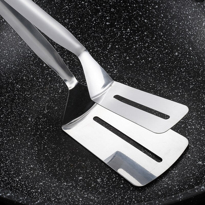 Ergonomic double-sided stainless steel spatula, an essential unisex kitchen tool for precise food flipping.