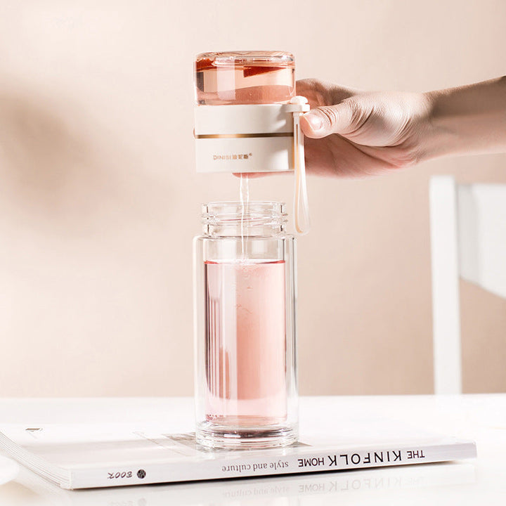 Insulated double-wall glass water bottle. Keeps hot tea hot, cold water cold. Portable, leak-proof drinkware.