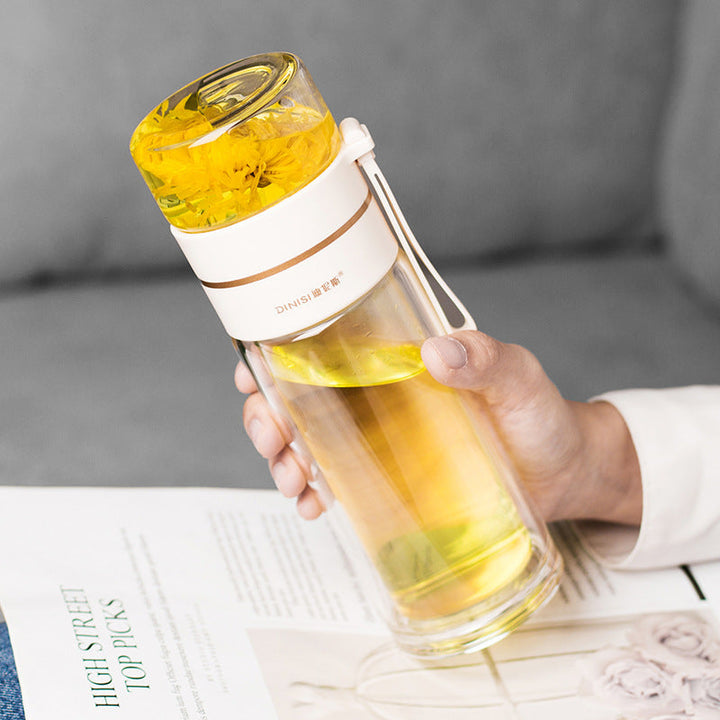 Clear glass water bottle with built-in tea infuser for loose leaf & fruit. Eco-friendly & leak-proof.