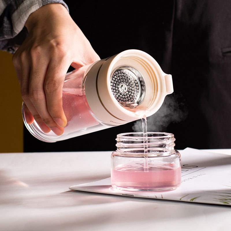 Elegant double-walled glass bottle for water, tea, coffee. Durable, eco-friendly, portable drinkware.