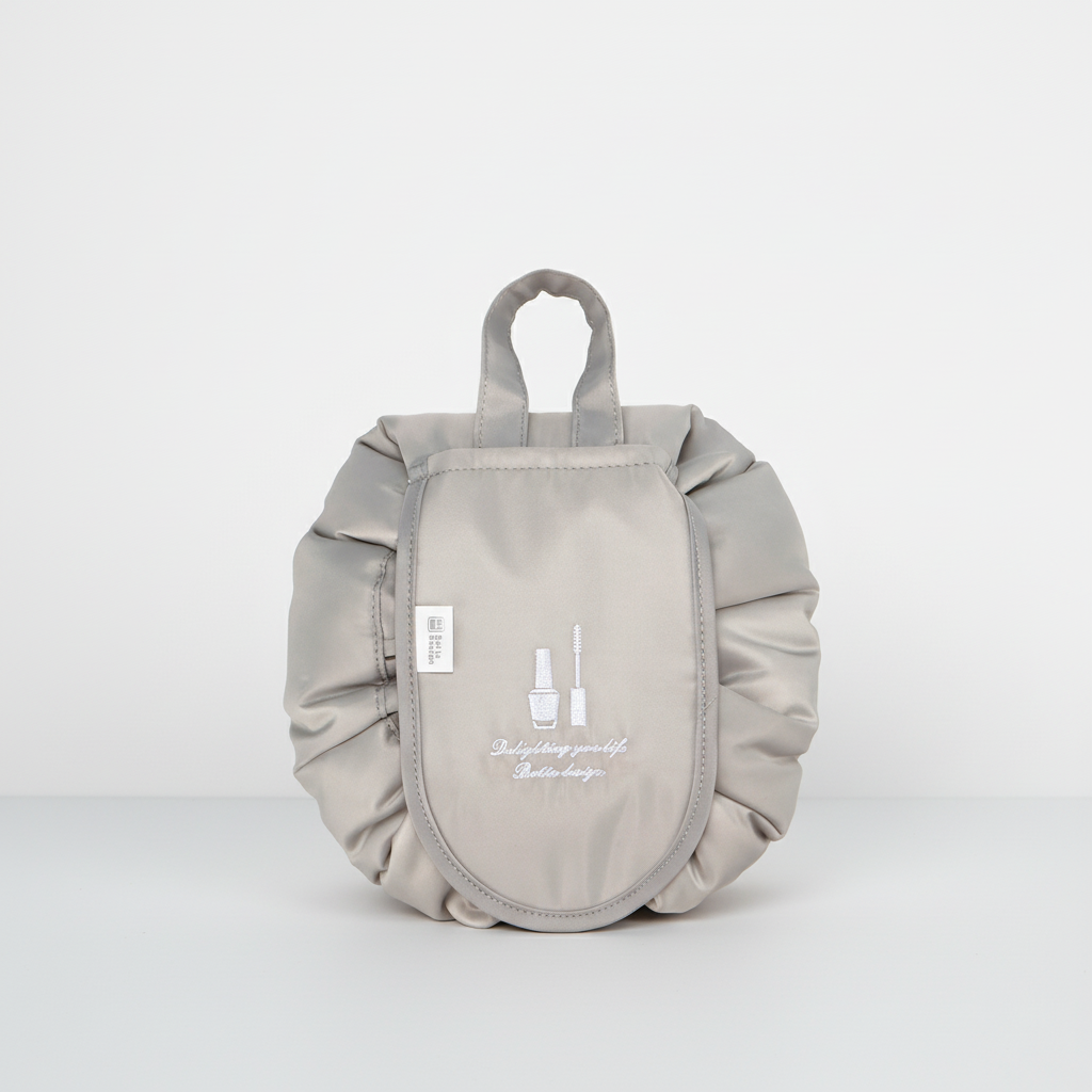 Waterproof GlamPouch makeup organizer, drawstring pouch, folded neatly for compact storage.