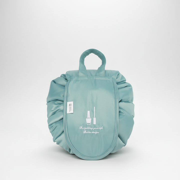 Unisex GlamPouch drawstring bag, open with various cosmetics inside, demonstrating easy access.