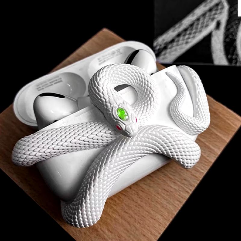 Elegant serpent design unisex earbud case. Durable & stylish protection for wireless headphones, a key tech accessory.