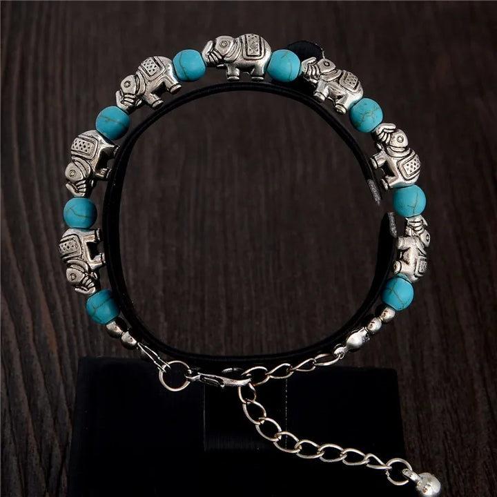 Handmade silver elephant charm bracelet with genuine crystal beads, a stylish unisex boho accessory.