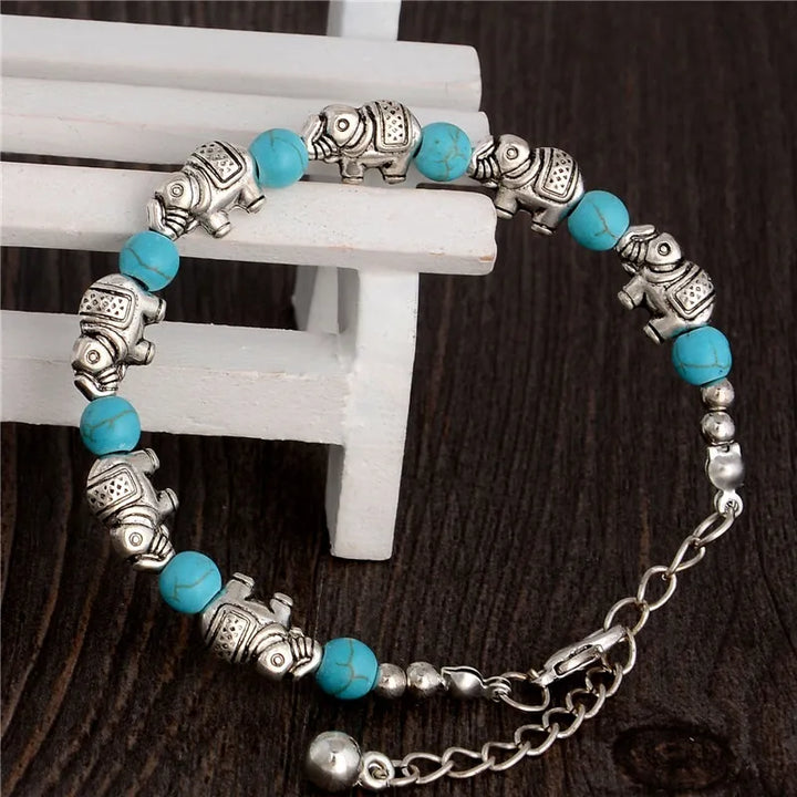 Elegant unisex elephant bracelet with faceted crystal beads and detailed silver charm, spiritual boho style.