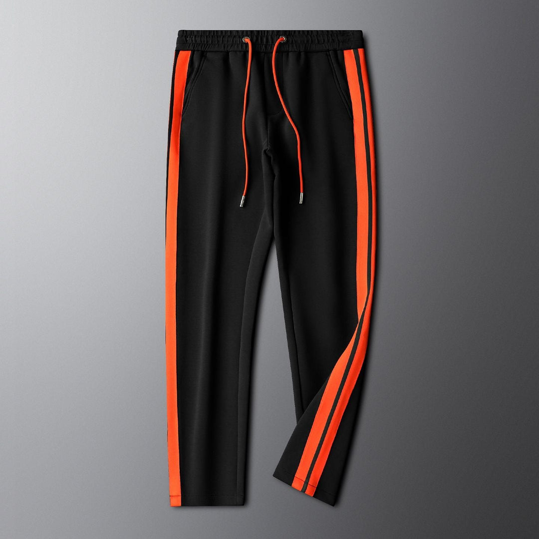 Unisex embroidered tracksuit modeled, showcasing modern design & athletic comfort. Ideal activewear for sports, workouts & casual style.