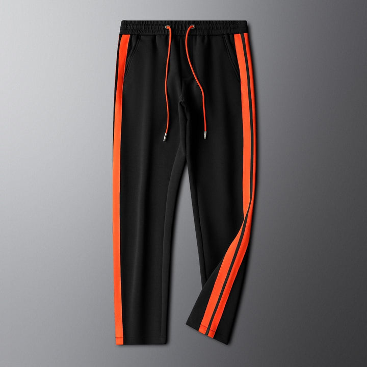Unisex embroidered tracksuit modeled, showcasing modern design & athletic comfort. Ideal activewear for sports, workouts & casual style.