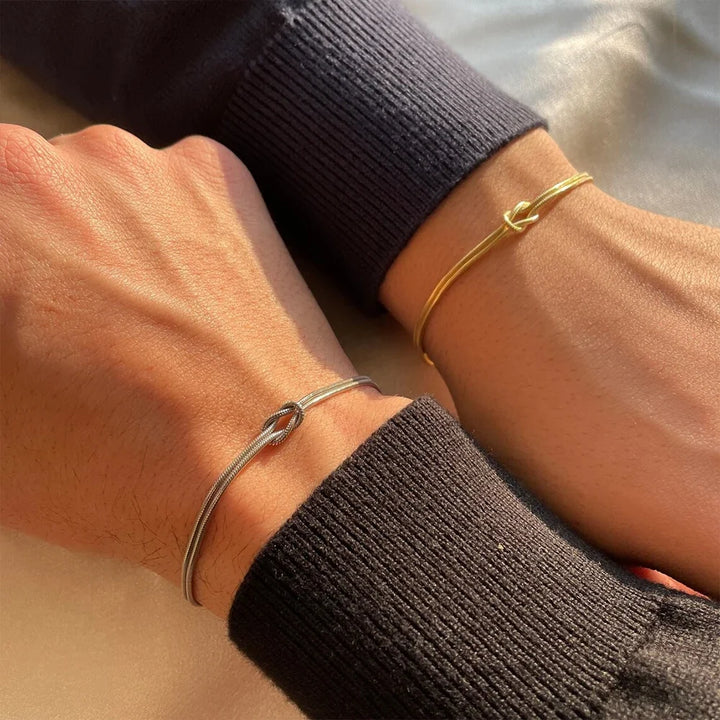Elegant Stainless Steel Endless Knot Bracelet. Adjustable minimalist design for daily wear, perfect unisex jewelry.