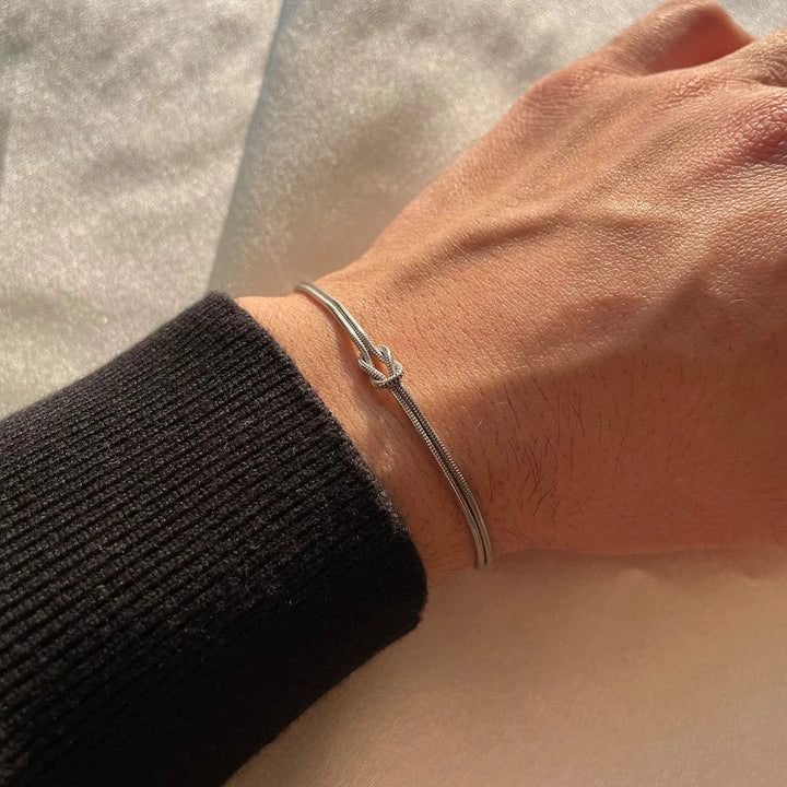Symbolic Endless Knot Bracelet. Polished stainless steel, adjustable & minimalist for a timeless unisex jewelry look.