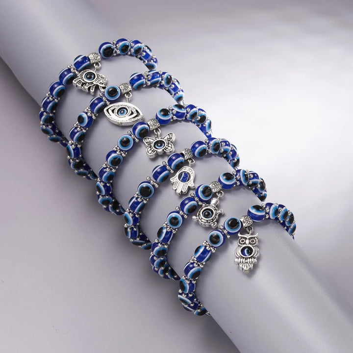 Unisex Evil Eye protection anklet stacked with other charm bracelets, creating a unique symbolic look.